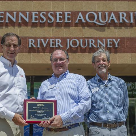 Dan Ashe, Keith Sanford and Jackson Andrews with AZA certification plaque in front of TN Aquarium.