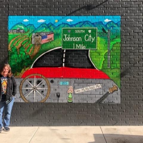 Artist Marci Berkhimer completes her Wagon Wheel themed mural in downtown Johnson City
